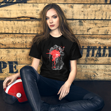 Load image into Gallery viewer, unisex black t-shirt, with image design of an angel kissing a woman, with a red paint splat seen through their outlines. Front view.