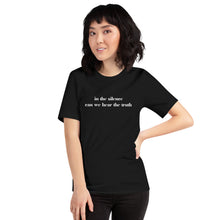 Load image into Gallery viewer, woman modeling/wearing unisex black t-shirt, with image phrase: "in the silence can we hear the truth." Front view.