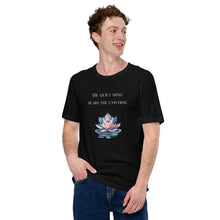 Load image into Gallery viewer, man modeling/wearing unisex black t-shirt, with image phrase: "The quiet mind hears the Universe." Image of watercolor pink and blue lotus flower floating on water.