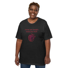 Load image into Gallery viewer, woman modeling/wearing unisex black heather t-shirt, with image design: red half brain, half heart. Image phrase: Red text - Change your thoughts, change your world. Front view.