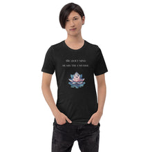 Load image into Gallery viewer, man modeling/wearing unisex black heather t-shirt, with image phrase: "The quiet mind hears the Universe." Image of watercolor pink and blue lotus flower floating on water.