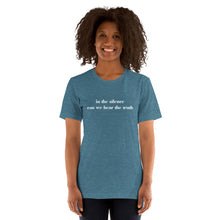 Load image into Gallery viewer, woman modeling/wearing unisex heather deep teal t-shirt, with image phrase: "in the silence can we hear the truth." Front view.