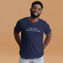 Load image into Gallery viewer, man modeling/wearing unisex navy blue t-shirt, with image phrase: "in the silence can we hear the truth." Front view.
