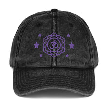 Load image into Gallery viewer, vintage denim cap black, with image design of purple third eye chakra symbol, and stars. Front view.
