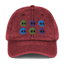 Load image into Gallery viewer, vintage denim cap maroon, with image design of 6 purple, green, and blue skulls, 2 of each color, in two rows. Front view.