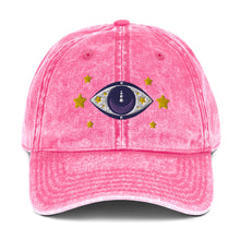Load image into Gallery viewer, vintage denim cap pink, with image design of blue eye of protection/evil eye/third eye, with stars. Front view.