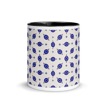 Load image into Gallery viewer, 11 oz. white ceramic coffee/tea mug with solid black handle, rim, and inside. Wrapped around mug is patterned image of eye of protection/evil eye. Outside middle view.