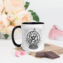 Load image into Gallery viewer, 11 oz. white ceramic coffee/tea mug with solid black handle, rim, and inside. Image Design: crystal ball with flaming pentacle inside, and hands cupping the crystal ball on both sides. left hand side view. halloween, spooky season.