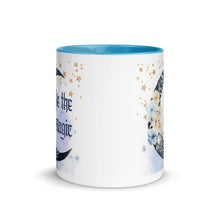 Load image into Gallery viewer, 11 oz. white ceramic coffee/tea mug with solid light blue handle, rim, and inside. Image Design: watercolor blue crescent moon, with flowers, daisies, lilies, butterflies. Stars in background, smoky purple background. Image phrase: Be the Magic. Center front view. Halloween, spooky season.