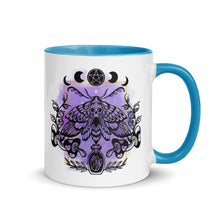 Load image into Gallery viewer, 11 oz. white ceramic coffee/tea mug with solid light blue handle, rim, and inside. Design: Moth with a skull, moon phases, pentacle, mushrooms, and a crystal vial. right hand side view.