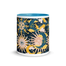 Load image into Gallery viewer, enchanting ceramic coffee tea mug featuring a wraparound image of an abstract sun, moon, and star pattern. light blue colorful rim, handle, and inside mug. Colors in pattern: golden yellow, dark teal, peach coral. Center view, outside.