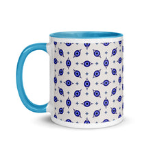 Load image into Gallery viewer, 11 oz. white ceramic coffee/tea mug with solid light blue handle, rim, and inside. Wrapped around mug is patterned image of eye of protection/evil eye. Left hand side view.