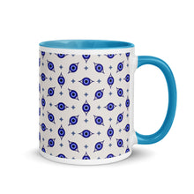 Load image into Gallery viewer, 11 oz. white ceramic coffee/tea mug with solid light blue handle, rim, and inside. Wrapped around mug is patterned image of eye of protection/evil eye. Right hand side view.