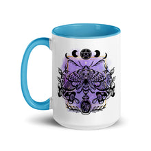 Load image into Gallery viewer, 15 oz. white ceramic coffee/tea mug with solid light blue handle, rim, and inside. Design: Moth with a skull, moon phases, pentacle, mushrooms, and a crystal vial. left hand side view.