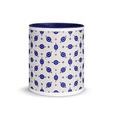 Load image into Gallery viewer, 11 oz. white ceramic coffee/tea mug with solid navy blue handle, rim, and inside. Wrapped around mug is patterned image of eye of protection/evil eye. Outside middle view.