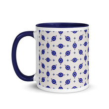 Load image into Gallery viewer, 11 oz. white ceramic coffee/tea mug with solid navy blue handle, rim, and inside. Wrapped around mug is patterned image of eye of protection/evil eye. Left hand side view.