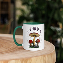 Load image into Gallery viewer, 11 oz. white ceramic coffee/tea mug with solid dark green handle, rim, and inside. Image Design: Mushroom cluster, moon phases, and constellations. left hand side view.