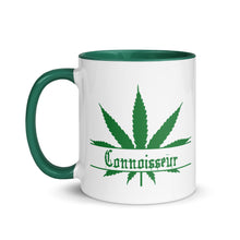 Load image into Gallery viewer, 11 oz. white ceramic coffee/tea mug with solid dark green handle, rim, and inside. Image Design: Marijuana leaf with "Connoisseur" text. Left hand side view.