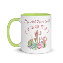 Load image into Gallery viewer, 11 oz. white ceramic coffee/tea mug with solid light green handle, rim, and inside. Image Design: Moon phases, colorful pink and green tinged cacti, with "Stay Wild Moon Child" text. Left hand side view.
