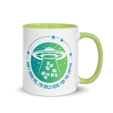 Load image into Gallery viewer, 11 oz. white ceramic coffee/tea mug with solid light green handle, rim, and inside. Image Design: ufo ship abducting/beaming up coffee beans. background blue to light green gradient, stars. Text under image: "Don't mind me, I'm only here for the Coffee." Right hand side view.