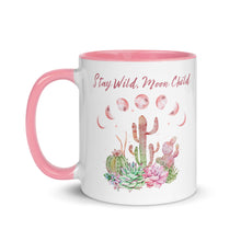 Load image into Gallery viewer, 11 oz. white ceramic coffee/tea mug with solid light pink handle, rim, and inside. Image Design: Moon phases, colorful pink and green tinged cacti, with "Stay Wild Moon Child" text. Left hand side view.