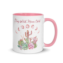 Load image into Gallery viewer, 11 oz. white ceramic coffee/tea mug with solid light pink handle, rim, and inside. Image Design: Moon phases, colorful pink and green tinged cacti, with "Stay Wild Moon Child" text. Right hand side view.