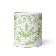 Load image into Gallery viewer, 11 oz. White glossy ceramic coffee/tea mug. Image Design: Green marijuana leaves with gold edges and classy dots, wrapped around print. Front side center view.