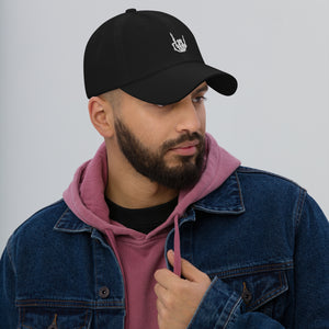 Man modeling/wearing Black Baseball cap, classic visor shape. Image Design: "Rock On" skeleton hand gesture on the front. Right side view.