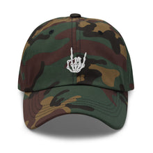 Load image into Gallery viewer, Camouflage print Baseball cap, classic visor shape. Image Design: &quot;Rock On&quot; skeleton hand gesture on the front. Front center view.
