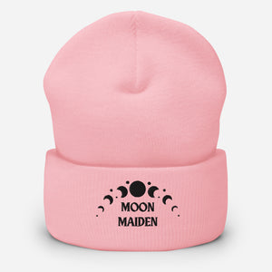 cuffed beanie baby pink, with image phrase "Moon Maiden," and image graphic of moon phases. background: winter themed, Christmas gifts.