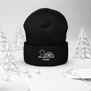 beanie black , with image design of an eye in a cloud, with moon crescent and stars, with the word "Breathe" underneath the image. Front view.