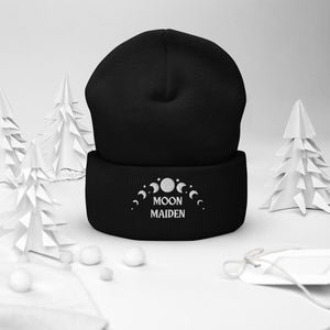 cuffed beanie black, with image phrase "Moon Maiden," and image graphic of moon phases. background: winter themed, Christmas gifts.