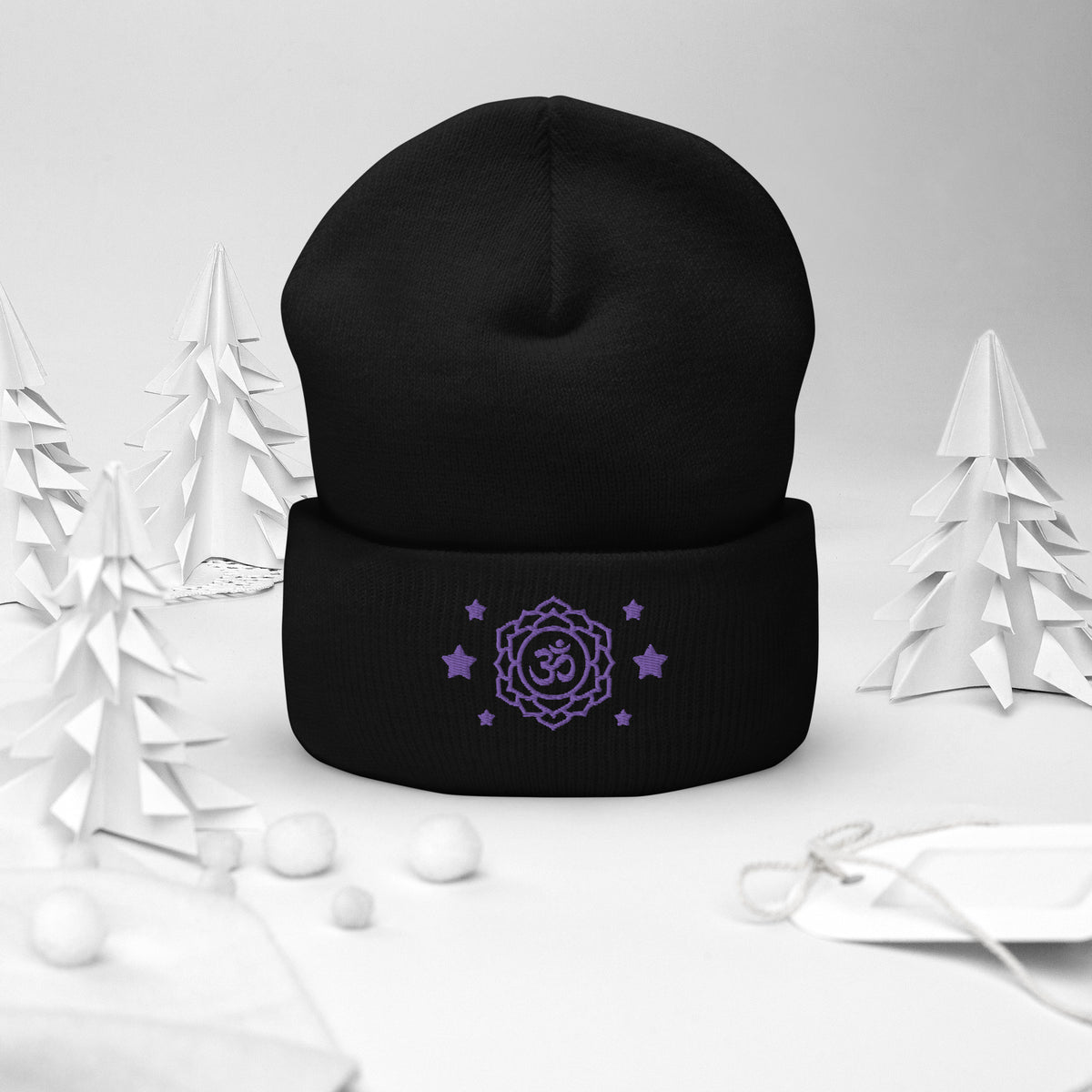 cuffed beanie black, with image design of purple third eye chakra symbol, with purple stars. background: winter themed, Christmas gifts.