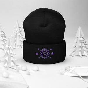 cuffed beanie black, with image design of purple third eye chakra symbol, with purple stars. background: winter themed, Christmas gifts.