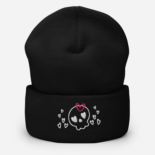 beanie black , with image design of a cartoonish cute skull with heart eyes, a heart bow, and stars. Front view.