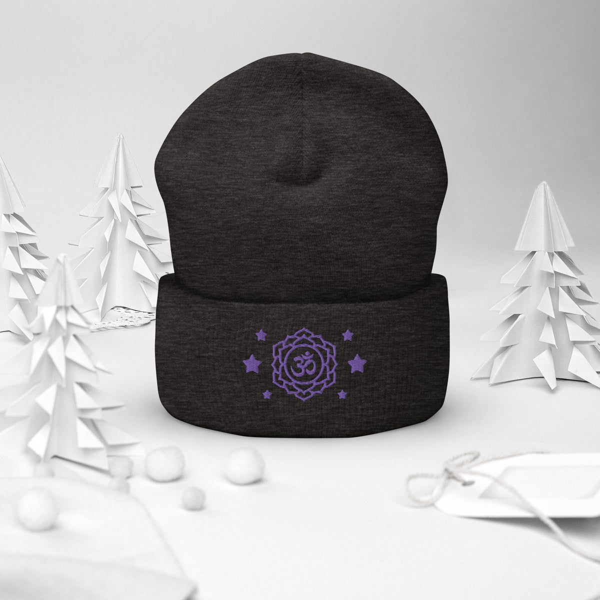 cuffed beanie dark grey, with image design of purple third eye chakra symbol, with purple stars. background: winter themed, Christmas gifts.
