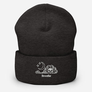 beanie dark grey, with image design of an eye in a cloud, with moon crescent and stars, with the word "Breathe" underneath the image. Front view.