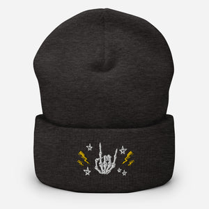 cuffed beanie dark grey, with image design of rock on skeleton hand, pentagram stars, lightning symbols. background: winter themed, Christmas gifts.