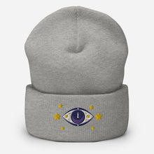 Load image into Gallery viewer, cuffed beanie heather grey, with image design of purple eye of protection/evil eye, with yellow stars. background: winter themed, Christmas gifts.
