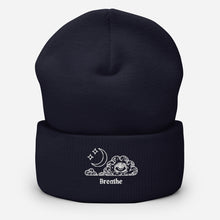 Load image into Gallery viewer, beanie navy blue, with image design of an eye in a cloud, with moon crescent and stars, with the word &quot;Breathe&quot; underneath the image. Front view.
