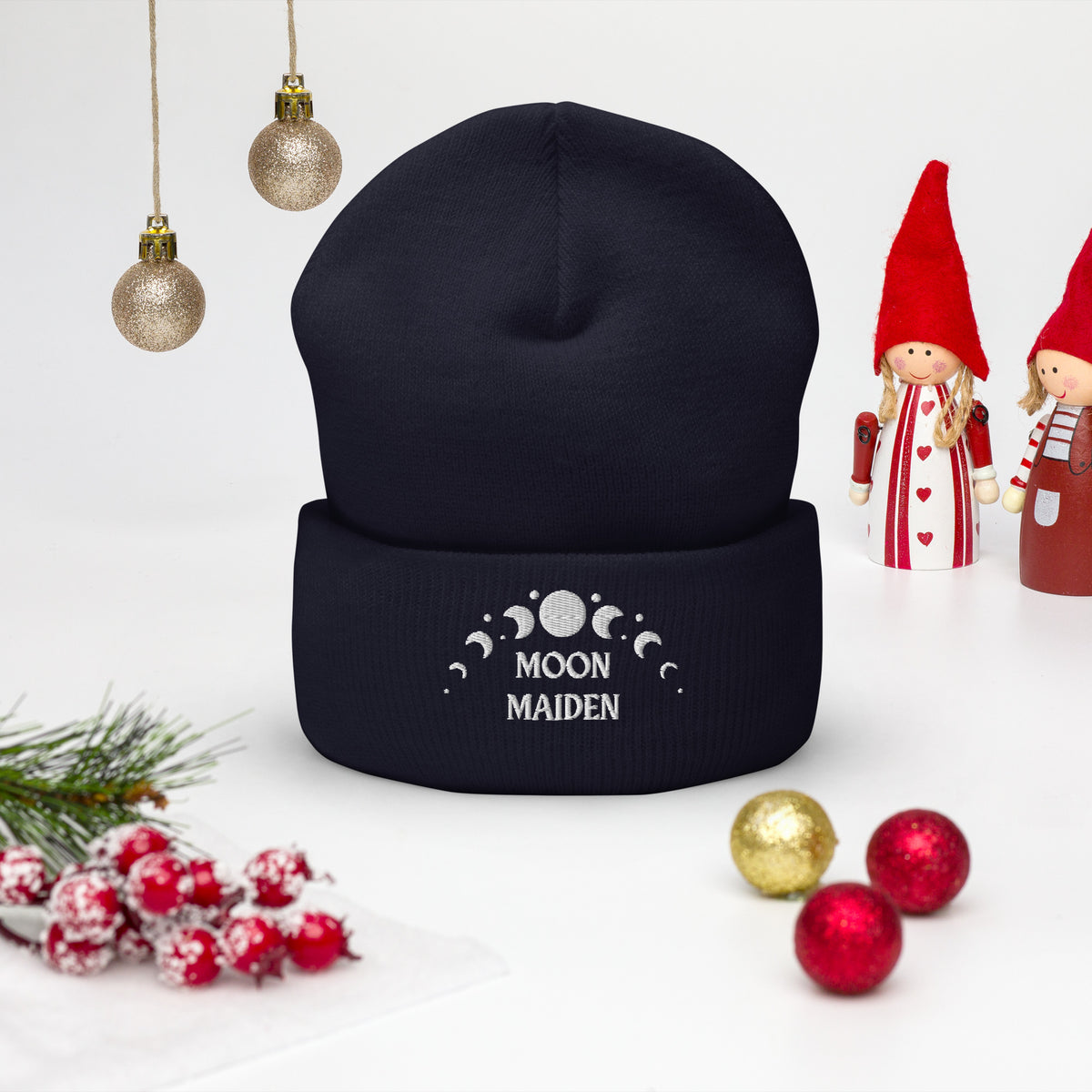 cuffed beanie navy blue , with image phrase "Moon Maiden," and image graphic of moon phases. background: winter themed, Christmas gifts.
