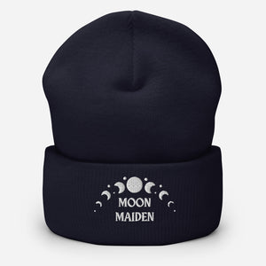 cuffed beanie navy blue, with image phrase "Moon Maiden," and image graphic of moon phases. background: winter themed, Christmas gifts.