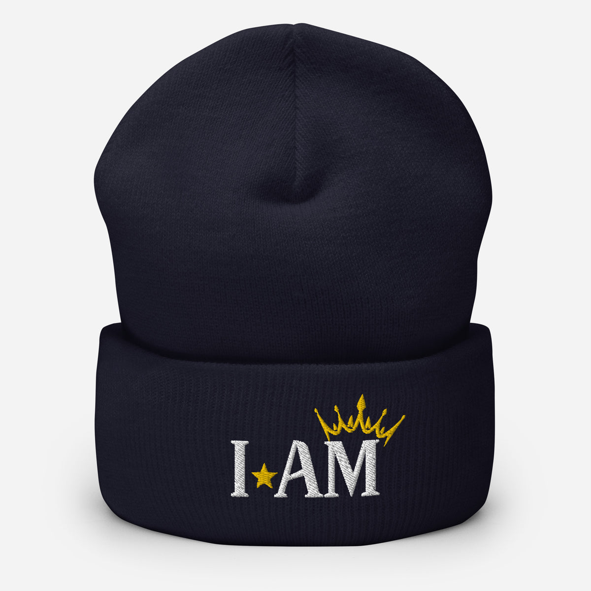 cuffed beanie navy blue , with image phrase "I AM," with image of a crown over the word AM. background: winter themed, Christmas gifts.