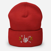 Load image into Gallery viewer, cuffed beanie red, with image design of rock on skeleton hand, pentagram stars, lightning symbols. background: winter themed, Christmas gifts.
