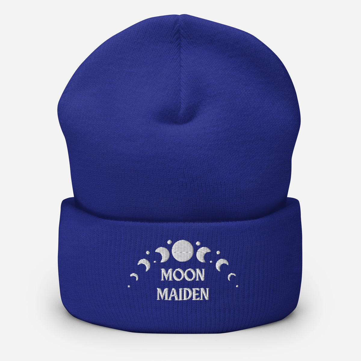 cuffed beanie royal blue, with image phrase "Moon Maiden," and image graphic of moon phases. background: winter themed, Christmas gifts.