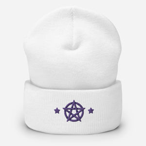 cuffed beanie white, with image design of purple pentacle and stars. background: winter themed, Christmas gifts.