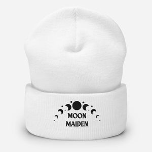 cuffed beanie white, with image phrase "Moon Maiden," and image graphic of moon phases. background: winter themed, Christmas gifts.