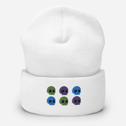 beanie white, with image design of 6 purple, green, and blue skulls, 2 of each color, in two rows.  Front view.