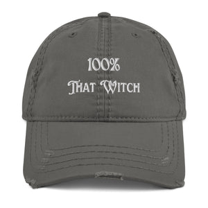 Charcoal grey distressed hat. Baseball cap. Phrase: 100% That Witch. Featuring bold embroidered white lettering on the front, playful and stylish. Front side center view.