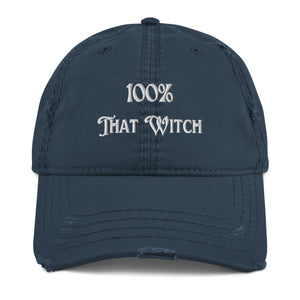 Vintage navy blue distressed hat. Baseball cap. Phrase: 100% That Witch. Featuring bold embroidered white lettering on the front, playful and stylish. Front side center view.